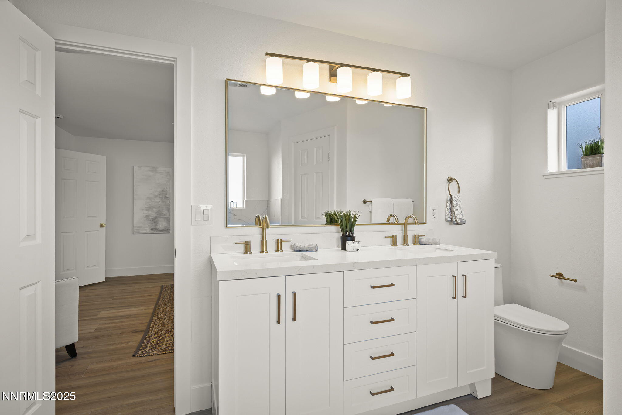1855 Hunter Lake Drive Reno, NV 89509 - Photo 24 of 37 a bathroom with a double vanity sink a toilet and a mirror