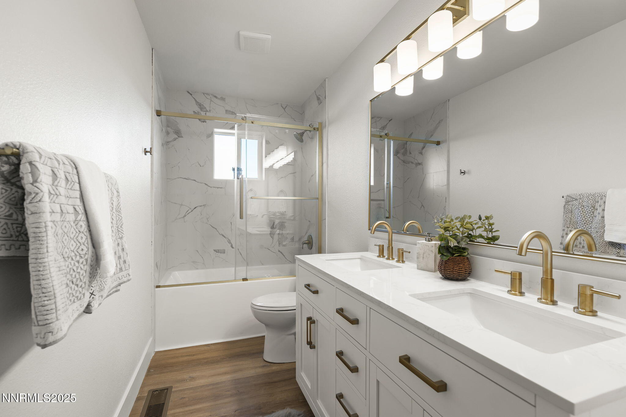 1855 Hunter Lake Drive Reno, NV 89509 - Photo 27 of 37 a bathroom with a double vanity sink toilet and shower