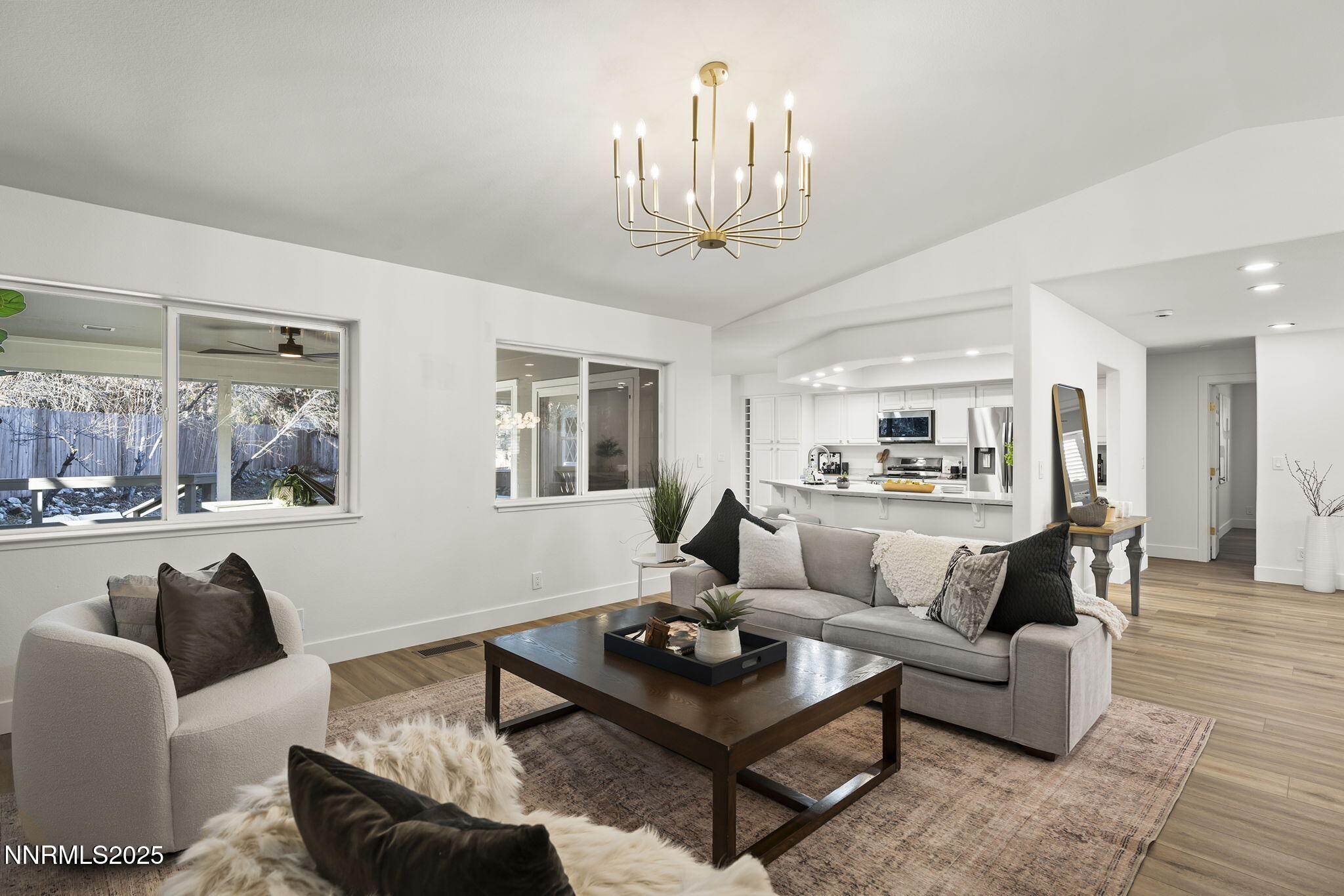 1855 Hunter Lake Drive Reno, NV 89509 - Photo 7 of 37 a living room with furniture a chandelier and a view of kitchen