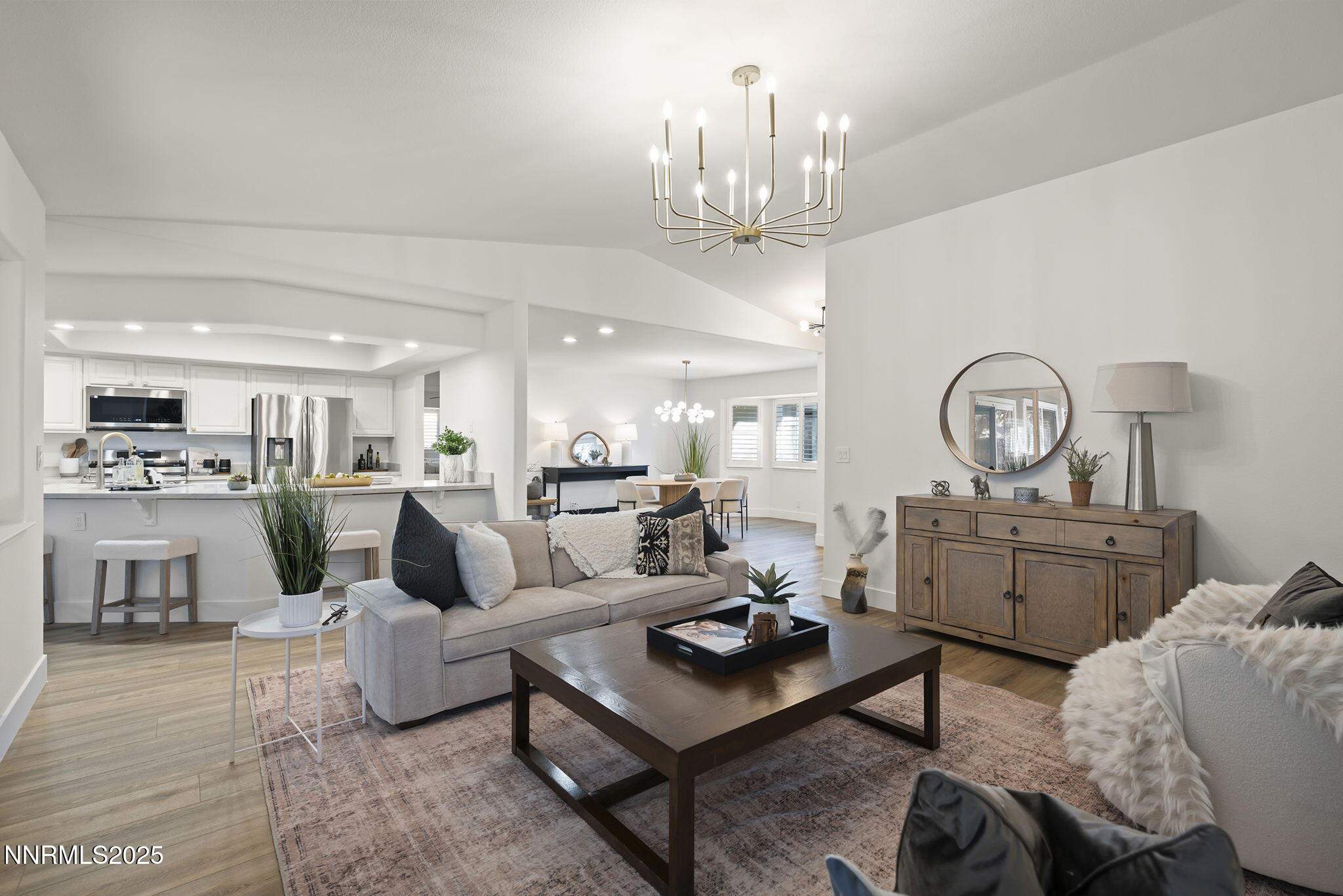 1855 Hunter Lake Drive Reno, NV 89509 - Photo 8 of 37 a living room with furniture a chandelier and kitchen view