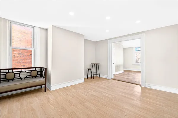 a view of empty room with wooden floor