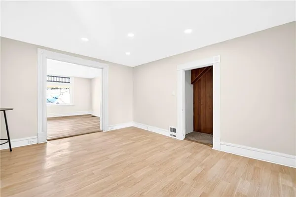 a living room with furniture a flat screen tv and a window