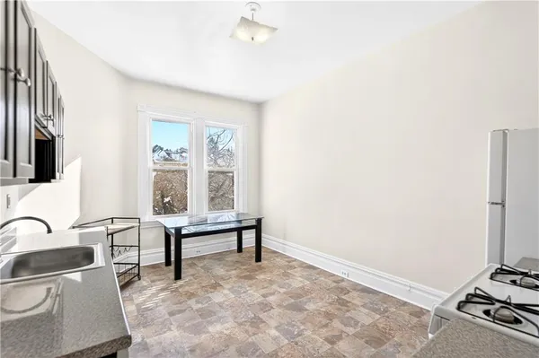 a kitchen with stainless steel appliances granite countertop a stove a sink and a refrigerator