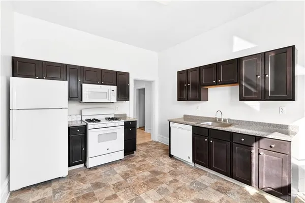 a kitchen with a sink cabinets and window