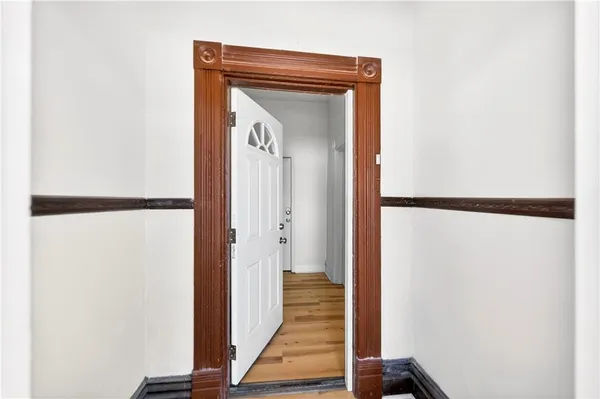 a view of a hallway with wooden floor