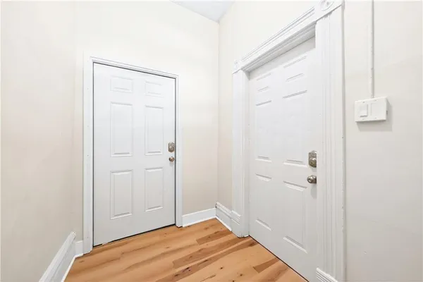 a view of an empty room with wooden floor