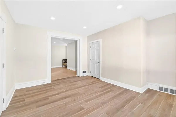 a view of an empty room and wooden floor