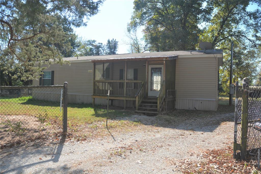 a backyard of a house with barbeque oven and outdoor seating
