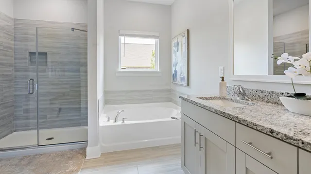 a bathroom with a granite countertop sink a toilet and bathtub
