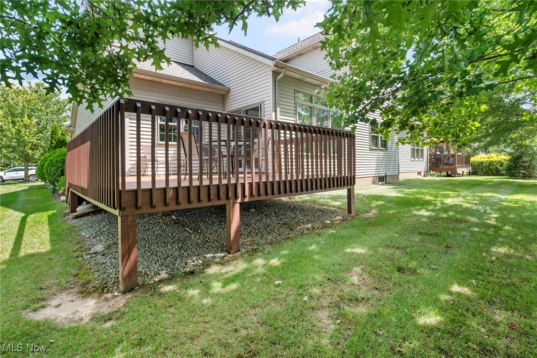 2503 Charing Cross Road Northwest Canton, OH 44708 - Photo 29 of 30 Rear view of property with a wooden deck and a lawn