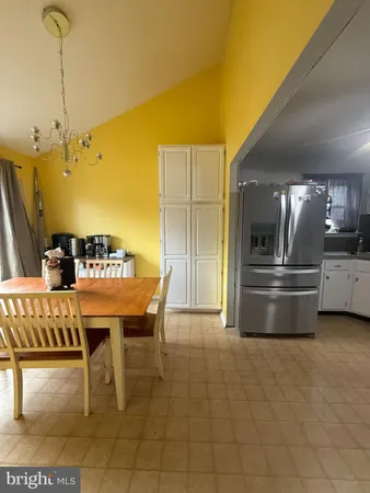 a kitchen with stainless steel appliances kitchen island granite countertop a table and chairs