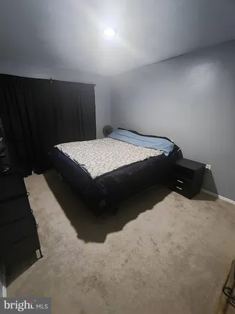 a bedroom with a bed and mirror