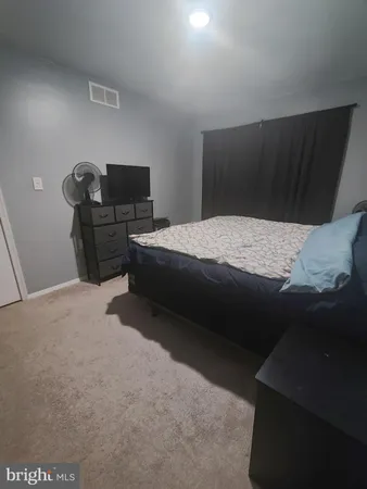 a bedroom with bed and window