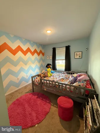 a bedroom with a bed and a mirror