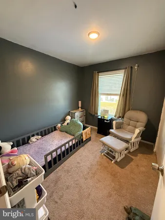 a bedroom with two beds and a window