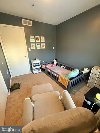 a bedroom with two beds and painted walls