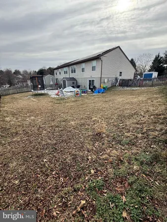 a view of swimming pool with outdoor seating and covered with wooden fence