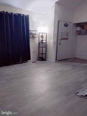 a view of an empty room with closet