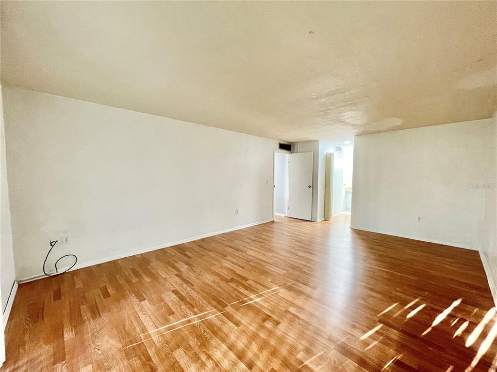 719 Southwest 75th Street, Unit 103 Gainesville, FL 32607 - Photo 13 of 39 a view of an empty room and wooden floor