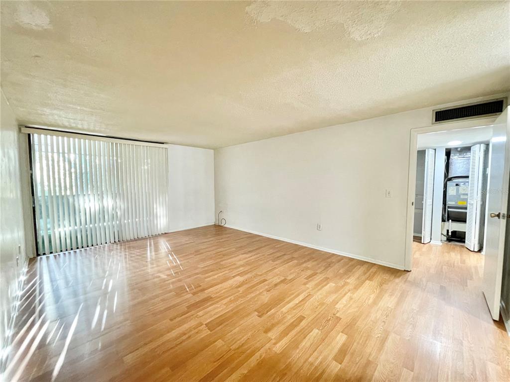 719 Southwest 75th Street, Unit 103 Gainesville, FL 32607 - Photo 15 of 39 a view of empty room with wooden floor