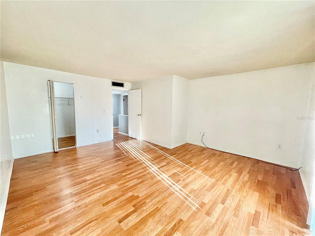 719 Southwest 75th Street, Unit 103 Gainesville, FL 32607 - Photo 25 of 39 a view of empty room with wooden floor