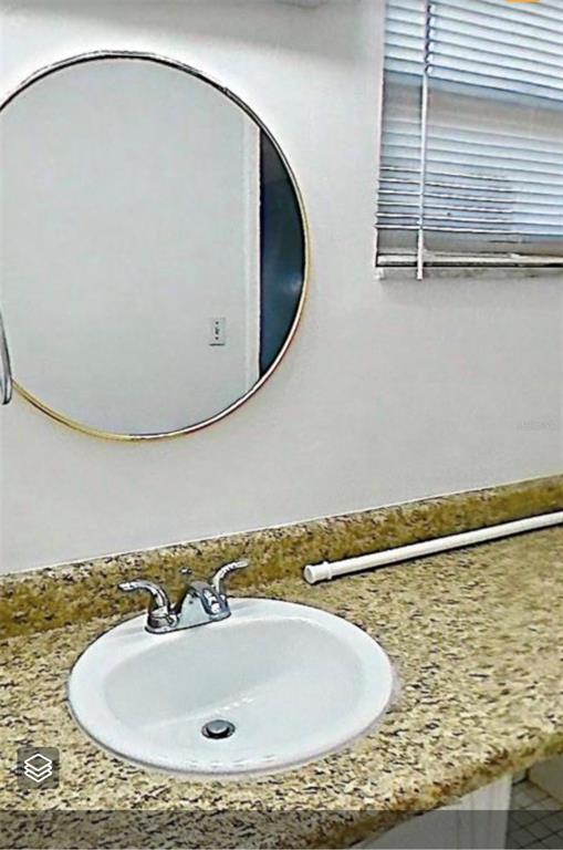 719 Southwest 75th Street, Unit 103 Gainesville, FL 32607 - Photo 28 of 39 a bathroom with a sink and a mirror