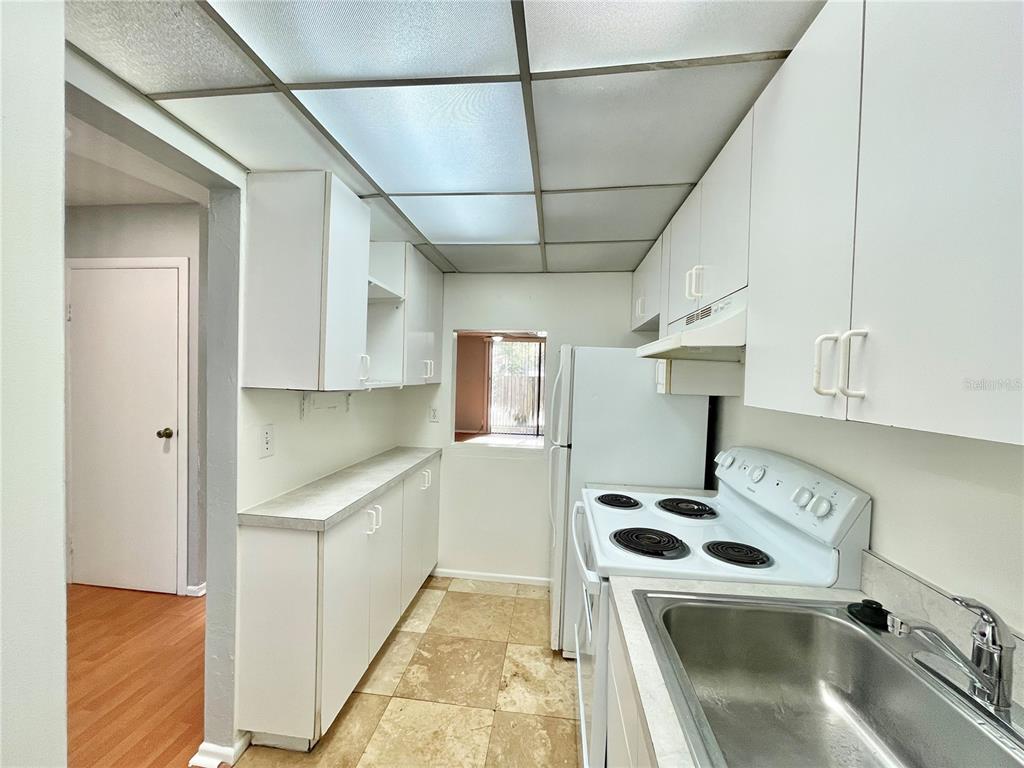719 Southwest 75th Street, Unit 103 Gainesville, FL 32607 - Photo 4 of 39 a kitchen with a sink a stove and cabinets