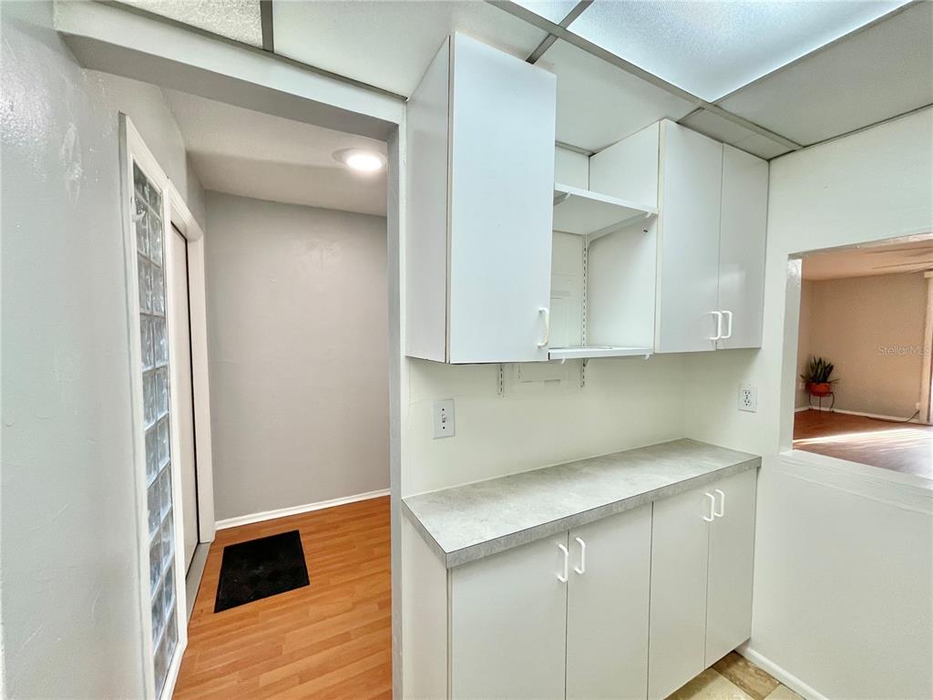 719 Southwest 75th Street, Unit 103 Gainesville, FL 32607 - Photo 6 of 39 a kitchen with stainless steel appliances white cabinets and a wooden floor