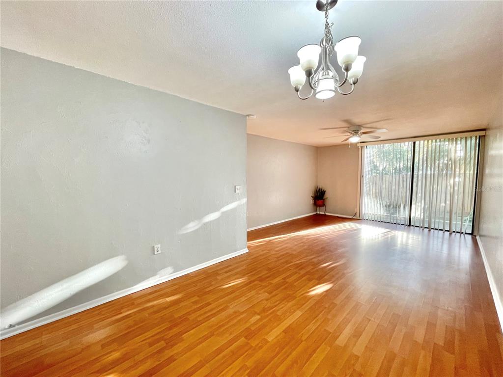 719 Southwest 75th Street, Unit 103 Gainesville, FL 32607 - Photo 7 of 39 a view of livingroom with hardwood floor and window