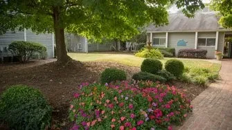 a front view of a house with a yard and fountain