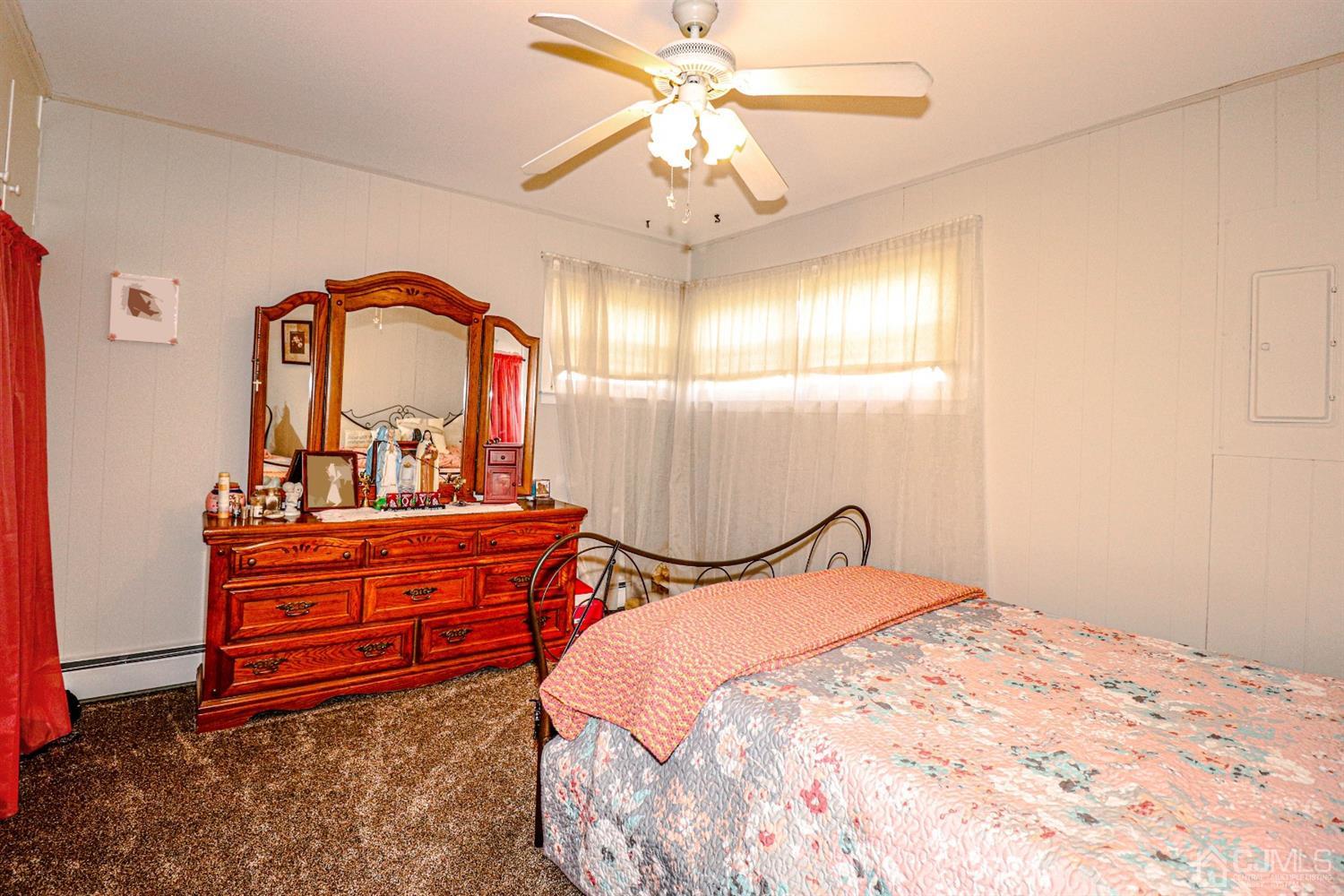 7 Dayton Road Edison, NJ 08817 - Photo 15 of 25 a bed room with a bed and a chandelier