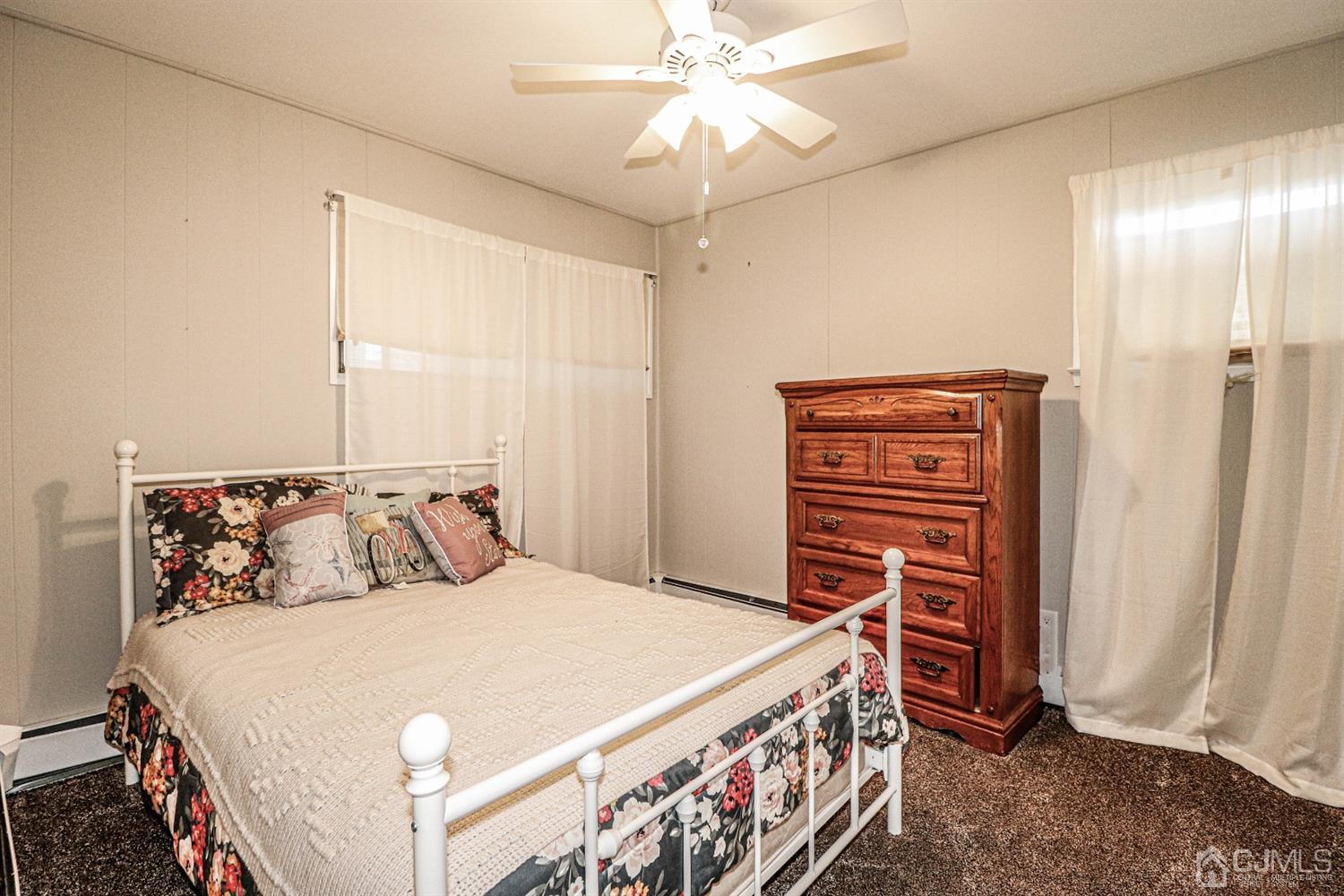 7 Dayton Road Edison, NJ 08817 - Photo 16 of 25 a bedroom with a bed and a chandelier