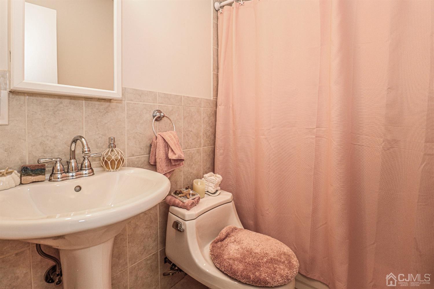 7 Dayton Road Edison, NJ 08817 - Photo 19 of 25 a bathroom with a sink a toilet and a mirror