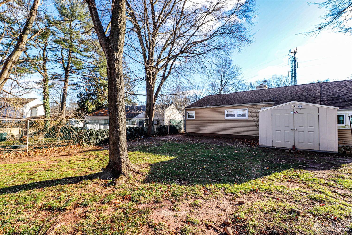 7 Dayton Road Edison, NJ 08817 - Photo 23 of 25 a view of a backyard with a large tree