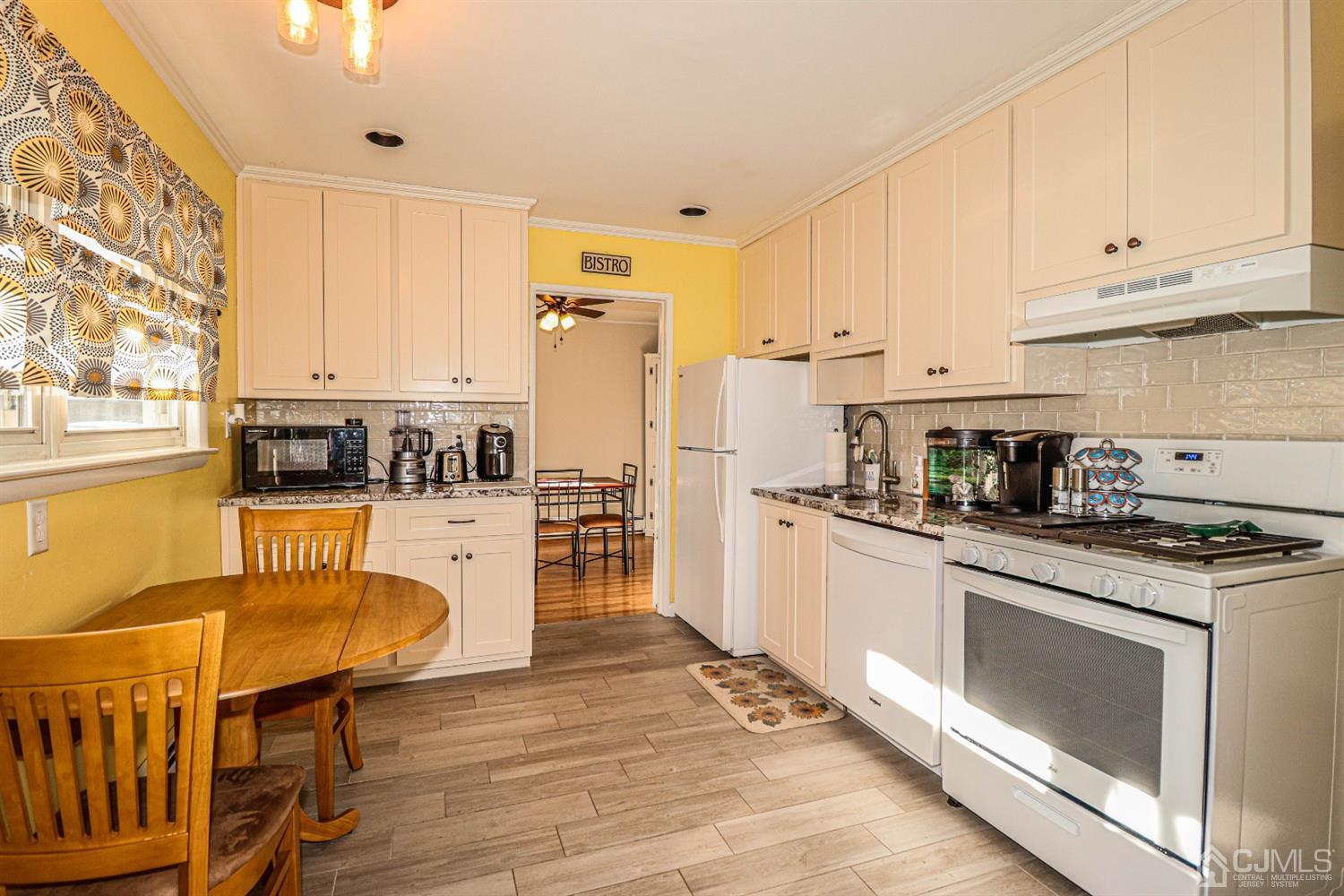 7 Dayton Road Edison, NJ 08817 - Photo 8 of 25 a kitchen with stainless steel appliances granite countertop a stove a sink dishwasher and a refrigerator with wooden floor