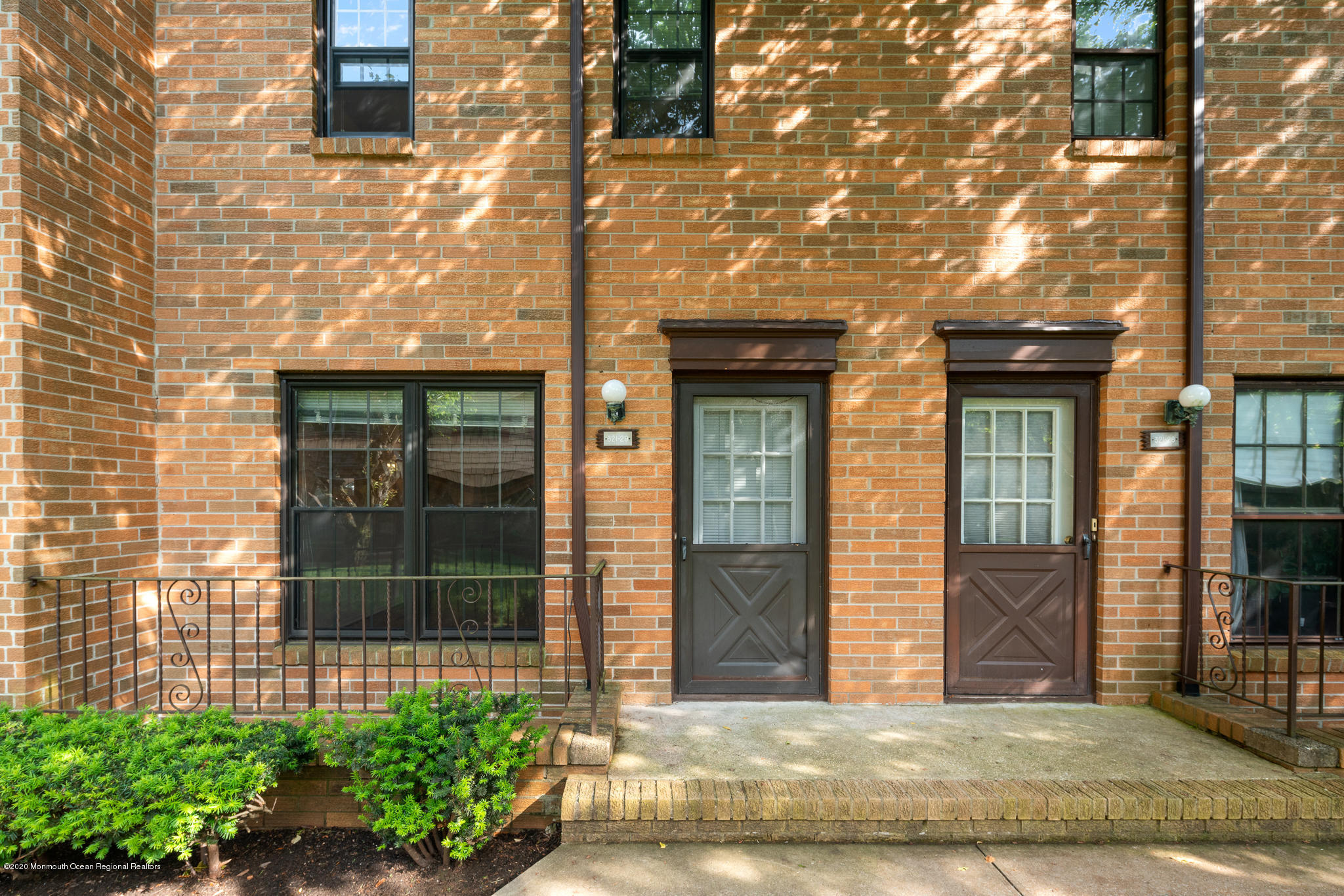 321 Spring Street, Unit 29 Red Bank, NJ 07701 - Photo 3 of 21 a view of a brick house with large windows