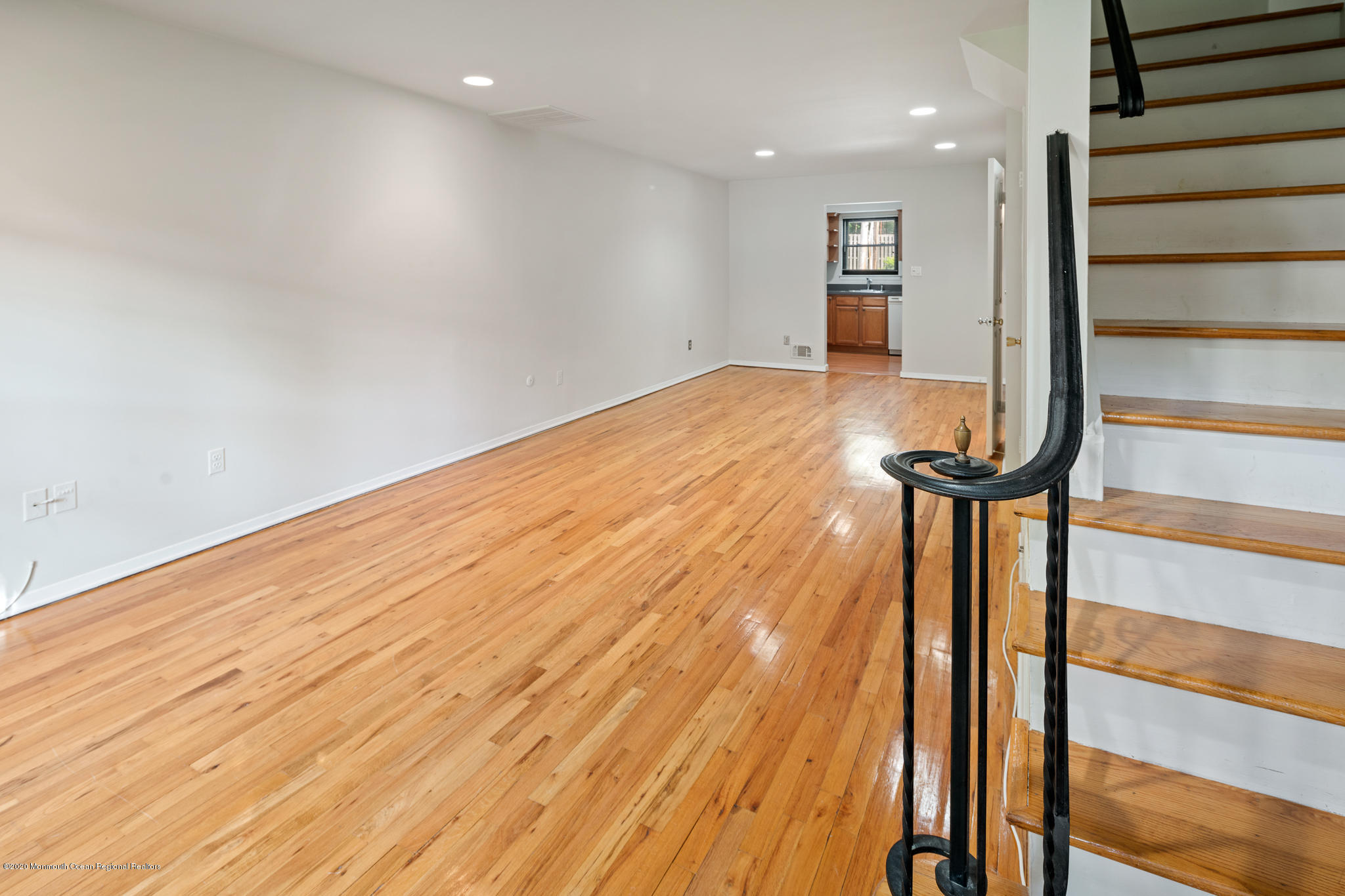 321 Spring Street, Unit 29 Red Bank, NJ 07701 - Photo 5 of 21 a view of a room with wooden floor and stairs