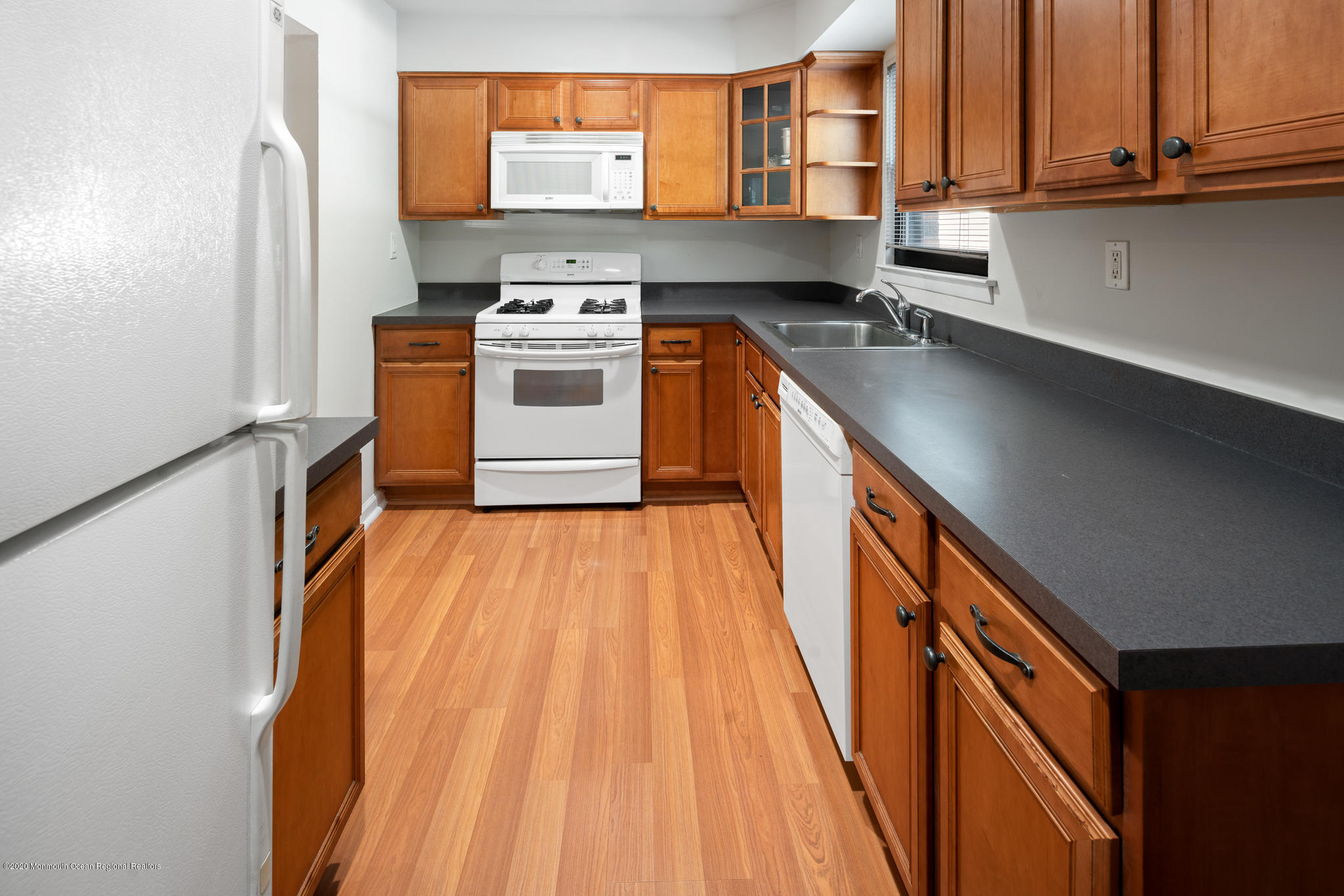 321 Spring Street, Unit 29 Red Bank, NJ 07701 - Photo 10 of 21 a kitchen with stainless steel appliances granite countertop a sink a stove and a wooden floors