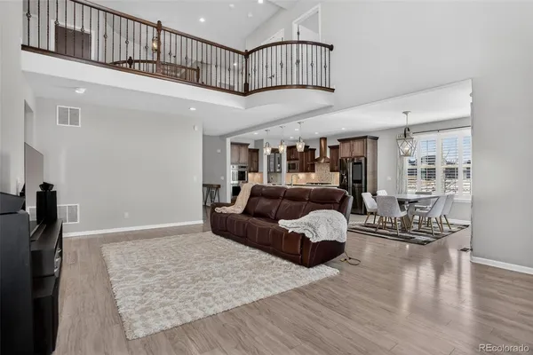 a living room with furniture wooden floor and a chandelier