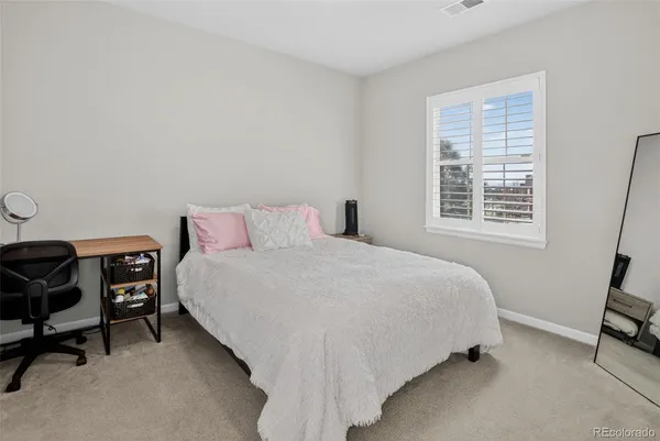a bedroom with a bed chair and a window