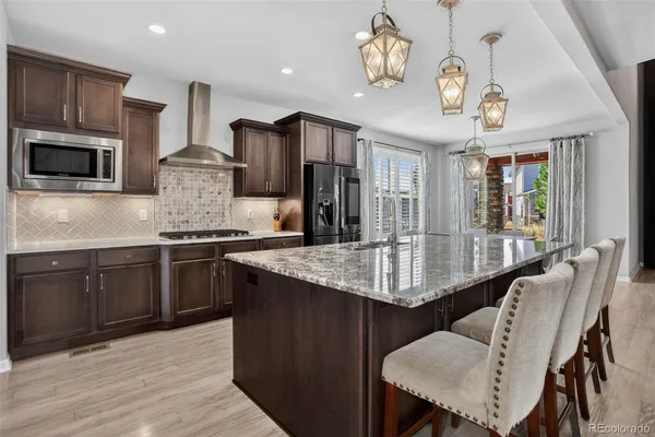 a kitchen with cabinets appliances and a dining table
