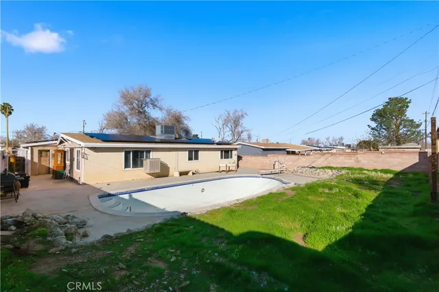 a view of a house with a yard and sitting area