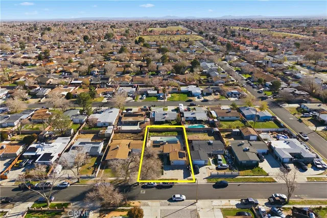 an aerial view of residential houses with city view
