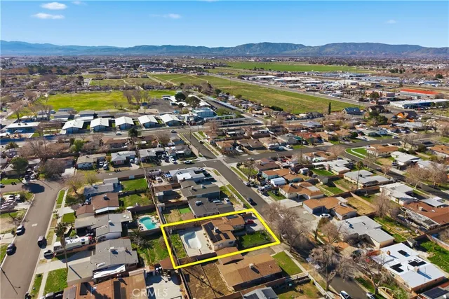 an aerial view of residential houses with outdoor space