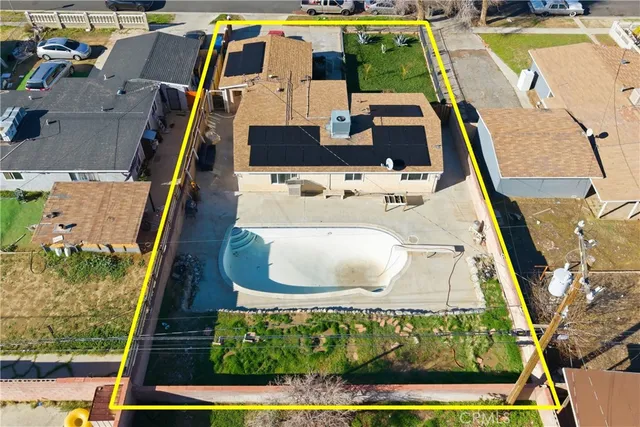 an aerial view of a house with a swimming pool