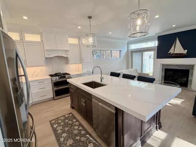 a view of a hallway with wooden floor and a living room