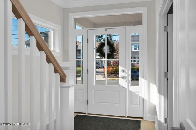 a view of a hallway to a livingroom with furniture