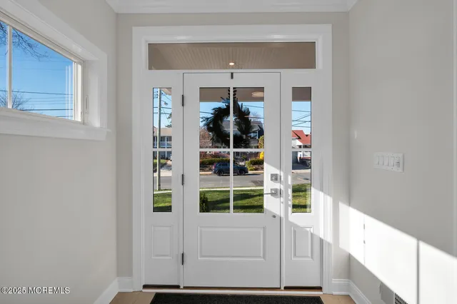 a kitchen with stainless steel appliances a table chairs and a refrigerator