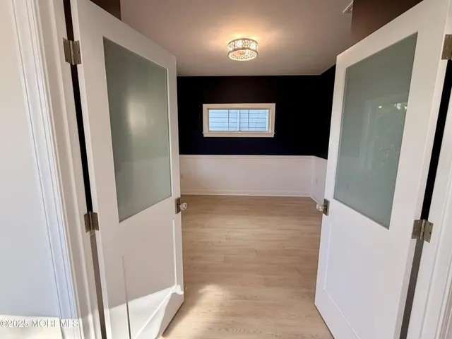 a kitchen with stainless steel appliances kitchen island granite countertop a table chairs refrigerator and microwave