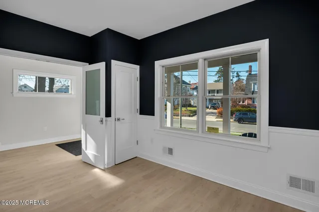 a kitchen with stainless steel appliances kitchen island granite countertop a dining table chairs and refrigerator